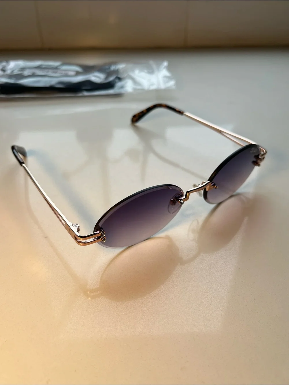 QUAY Literally Obsessed Rimless Oval Sunglasses-Rose Gold/Blue Pink Fade Lens
